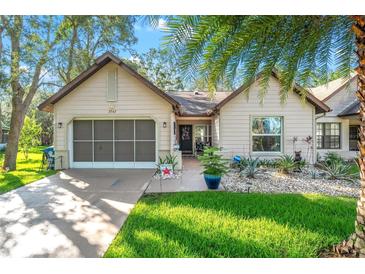 Charming single-story home featuring a well-manicured lawn and an attached two-car garage at 2342 Countryside Dr, Spring Hill, FL 34606