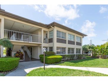 Well-maintained condo building with manicured landscaping and a convenient stairway entrance at 4754 Marine Pkwy # 103, New Port Richey, FL 34652