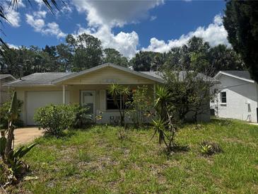 Charming one-story home with a welcoming front yard and mature trees at 6826 Driftwood Dr, Hudson, FL 34667