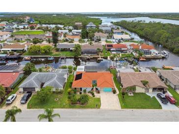 Waterfront homes with boat docks line the canals in this sunny, residential aerial view at 9921 San Mateo Way, Port Richey, FL 34668