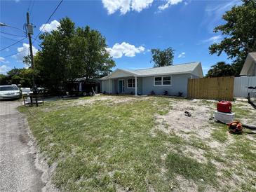 Charming single-story home featuring a well-maintained lawn, a cozy porch, and a freshly painted exterior at 11025 Harding Dr, Port Richey, FL 34668