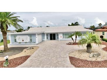Charming single story home with beautiful landscaping, brick paver driveway and front yard palm trees at 5339 Bowline Bnd, New Port Richey, FL 34652