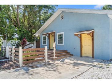 Charming light blue single-story home with a bright yellow door and inviting wooden porch steps at 5724 Casson Ave, New Port Richey, FL 34652