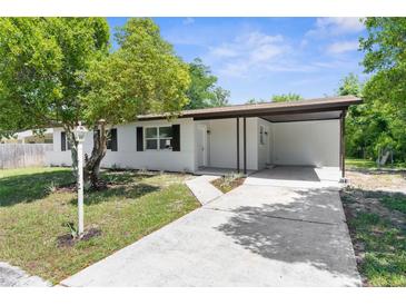 Charming single-story home with a covered carport and inviting front yard landscape at 7192 Catalina St, Spring Hill, FL 34606