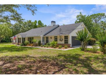 Charming single-story home with well-maintained landscaping and a welcoming front yard at 14645 Spellman Ct, Spring Hill, FL 34610