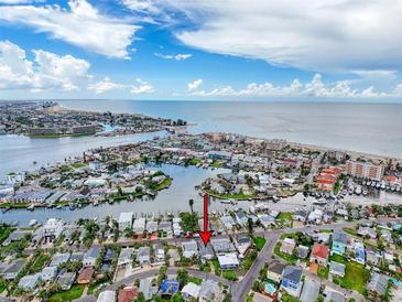 Island home with a waterfront canal, surrounded by water with beachfront and waterfront community at 336 Boca Ciega Dr, Madeira Beach, FL 33708