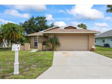 Inviting single-story home with a well-maintained lawn, two-car garage, and convenient mailbox at 4543 Dewey Dr, New Port Richey, FL 34652