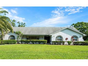 Charming single story home with a well manicured lawn, tasteful shrubbery and stone accents at 8522 Cranes Roost Dr, New Port Richey, FL 34654