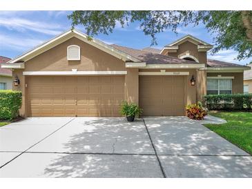 Charming single-Gathering home with a spacious three-car garage and manicured landscaping at 9309 Edistro Pl, New Port Richey, FL 34654