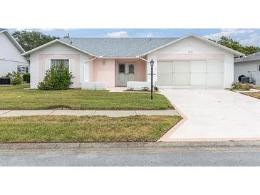 Charming single-story home with a well-manicured lawn and a two-car garage at 9433 Stonewall Ln, New Port Richey, FL 34655
