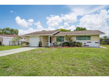 Charming single story home with a well-manicured lawn and front yard at 10600 Oleander Dr, Port Richey, FL 34668