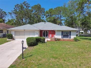 Charming one-story home with a well-manicured lawn and cozy front porch at 2183 Westchester Blvd, Spring Hill, FL 34606