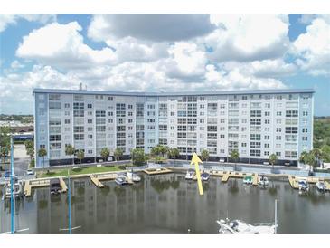 Waterfront condo building with boat docks, ideal for boating enthusiasts and enjoying waterfront living at 4939 Floramar Ter # 203, New Port Richey, FL 34652