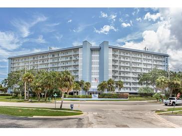 Stunning exterior view of a multi-story condominium complex with balconies and lush landscaping at 4939 Floramar Ter # 812, New Port Richey, FL 34652