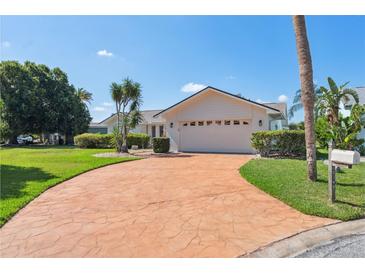 Charming single-story home with a well-maintained lawn and a stamped concrete driveway at 5348 Lawrence Ln, New Port Richey, FL 34652
