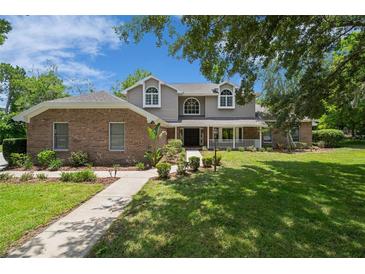 Charming two-story home with a brick facade and a well-manicured front yard at 7268 Crystal Spring Run, Weeki Wachee, FL 34607