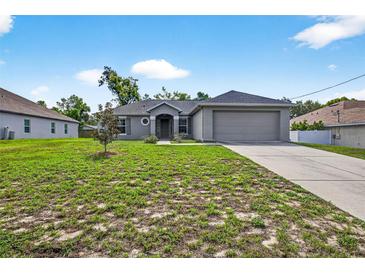 Charming single-story home with a well-manicured lawn and attached two-car garage at 2476 Magellan Ave, Spring Hill, FL 34608