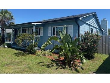 Charming blue home featuring manicured landscaping and a cozy front porch at 4027 31St N Ave, St Petersburg, FL 33713