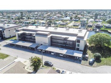 Beautiful condo building with canal access and covered parking for residents and guests at 4452 Garnet Dr # 302, New Port Richey, FL 34652