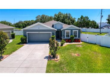 Charming single-story home with well-manicured lawn, attached garage, and beautiful landscaping at 8855 Prairie Creek Dr, New Port Richey, FL 34655