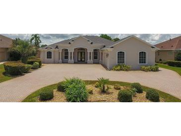 Elegant home featuring a large driveway, lush landscaping, and a meticulously maintained front yard at 9188 Mississippi Run, Weeki Wachee, FL 34613