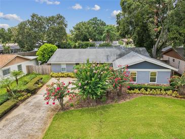 Charming single-story home featuring well-manicured landscaping, a lush green lawn, and a long driveway at 2827 Oak Tree Ln, Palm Harbor, FL 34684