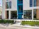 Modern building exterior with blue accents, commercial space, and landscaping at 1558 4Th St # 406, Sarasota, FL 34236