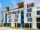 Modern building exterior with blue accents and balconies at 1558 4Th St # 406, Sarasota, FL 34236