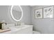 Elegant powder room with a lighted vanity mirror and modern fixtures at 1558 4Th St # 406, Sarasota, FL 34236