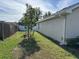 Side yard with young trees and a privacy fence at 593 Azure Rd, Venice, FL 34293