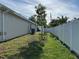 Side yard with young trees and a privacy fence at 593 Azure Rd, Venice, FL 34293