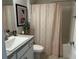 Clean bathroom with updated vanity, shower/tub combo, and patterned curtain at 593 Azure Rd, Venice, FL 34293