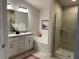 Spa-like bathroom with double vanity, soaking tub, and walk-in shower at 593 Azure Rd, Venice, FL 34293