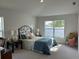 Main bedroom with carpet and large window at 593 Azure Rd, Venice, FL 34293