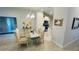 Elegant dining room with glass top table and kitchen access at 593 Azure Rd, Venice, FL 34293