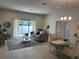 Open living room and dining area with tile floors and access to backyard at 593 Azure Rd, Venice, FL 34293