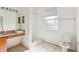 Bathroom featuring a sink, a walk-in shower, a toilet, and a frosted window at 2781 Shady Ave, North Port, FL 34286