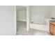 Bright bathroom featuring a white corner bathtub and neutral tile flooring at 2781 Shady Ave, North Port, FL 34286