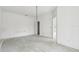 Unfurnished bedroom featuring bare concrete floors and an attached bathroom at 2781 Shady Ave, North Port, FL 34286