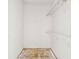 Empty closet showing two shelves, an unfinished floor and white walls at 2781 Shady Ave, North Port, FL 34286