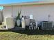 View of home utilities including the AC unit, pumps, and tanks at 2781 Shady Ave, North Port, FL 34286
