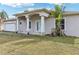 Charming single-story home with a stucco exterior, arched entryway, and well-maintained lawn at 2781 Shady Ave, North Port, FL 34286
