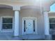 Charming front entryway featuring columns and a well-lit entrance, enhancing curb appeal at 2781 Shady Ave, North Port, FL 34286