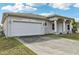 Front view of the house with a driveway and garage at 2781 Shady Ave, North Port, FL 34286