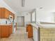 Kitchen showcasing a central island with a sink and wood cabinets at 2781 Shady Ave, North Port, FL 34286