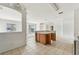 Spacious kitchen with a center island featuring a sink, cabinets, and tile flooring at 2781 Shady Ave, North Port, FL 34286