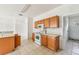 Kitchen featuring wood cabinets and white appliances at 2781 Shady Ave, North Port, FL 34286