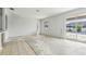 Spacious living room with sliding doors that open to a screened-in pool area at 2781 Shady Ave, North Port, FL 34286