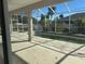 Pool area with view from home featuring a pool, screening, and backyard greenery at 2781 Shady Ave, North Port, FL 34286