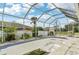 The screened-in pool with surrounding landscaping allows for private outdoor living at 2781 Shady Ave, North Port, FL 34286